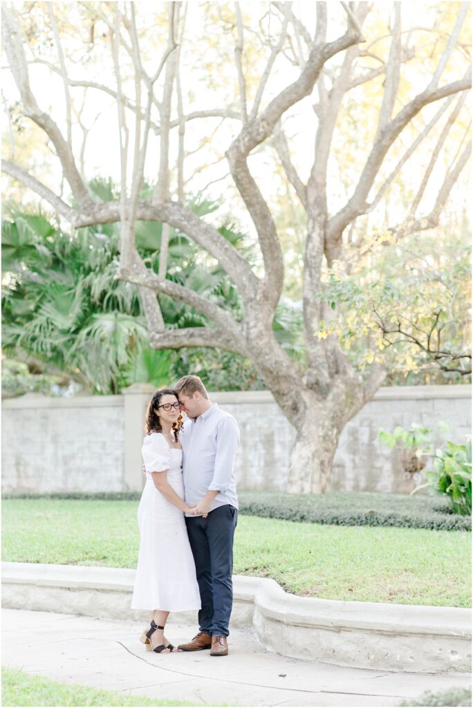 South Tampa Portrait Photographer. Bayshore Boulevard. Tampa Engagement Photography. White dress engagement outfit inspiration. Khaki Pants blue sports coat men outfit inspiration. engagement session with dog. 