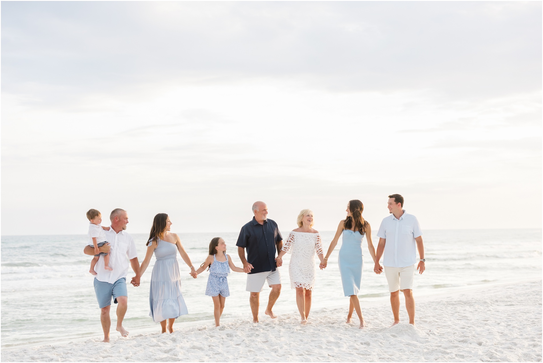 family photos in seaside florida. 30a florida beach photography. family beach photos in blue and white outfits.